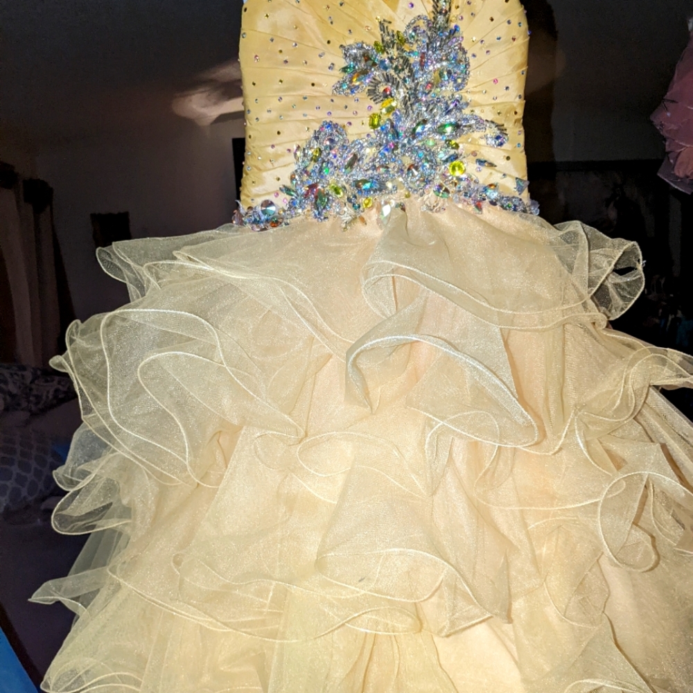 Tiffany size 4 pagent dress. Yellow with A/B stones hand glued to give it shine.